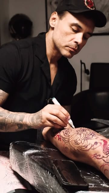 Tattoo artist at work in the Miami Beach studio