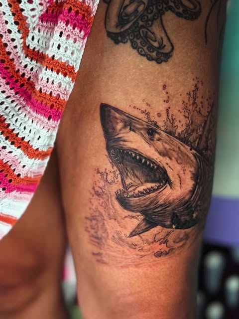 Shark tattoo with splashing water detail